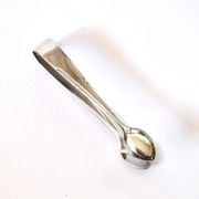 WMF vintage sugar tongs in silver-plated metal with crossed ribbon decoration.