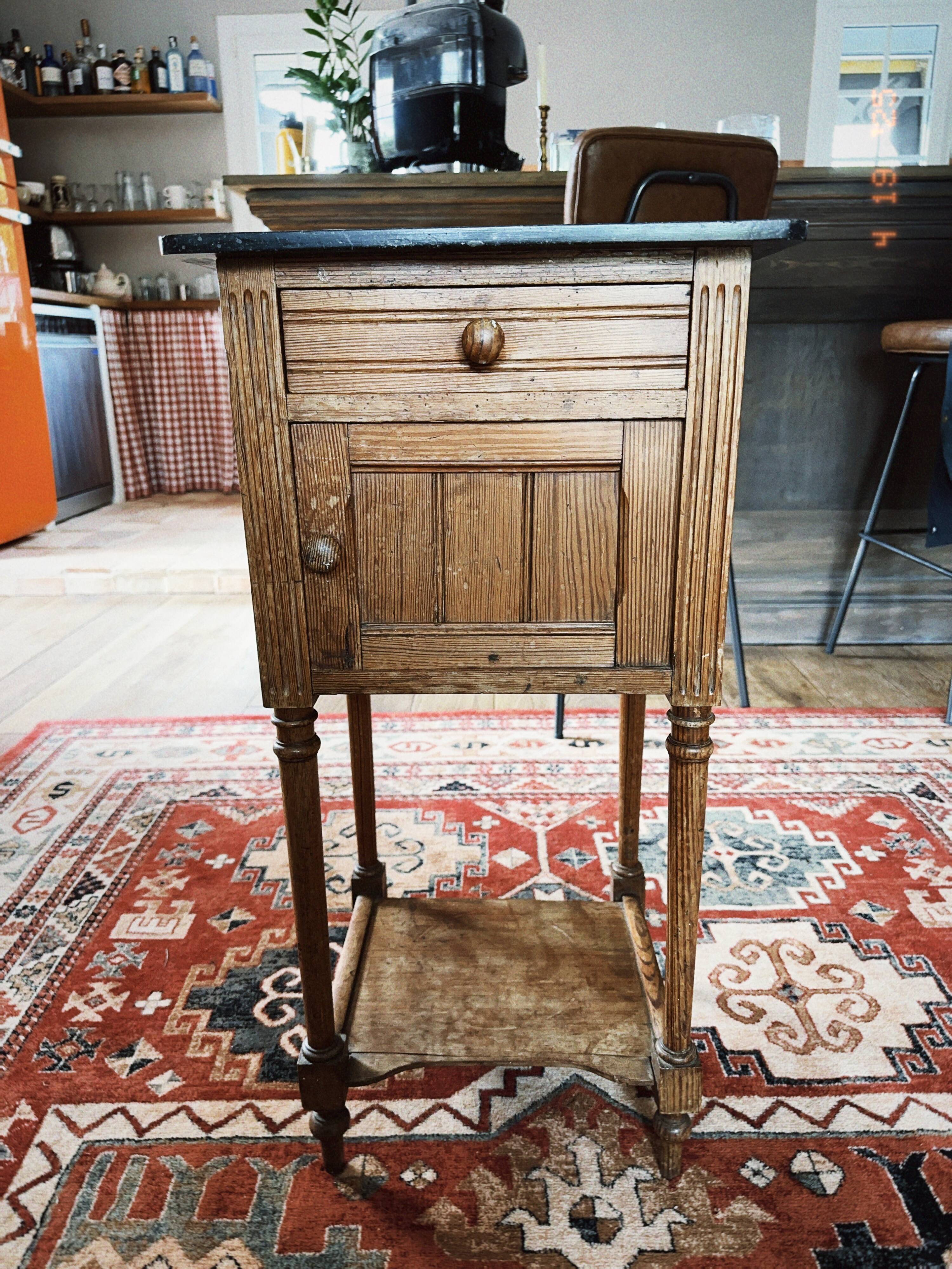 Antique wooden bedside table with marble top