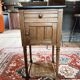Antique wooden bedside table with marble top
