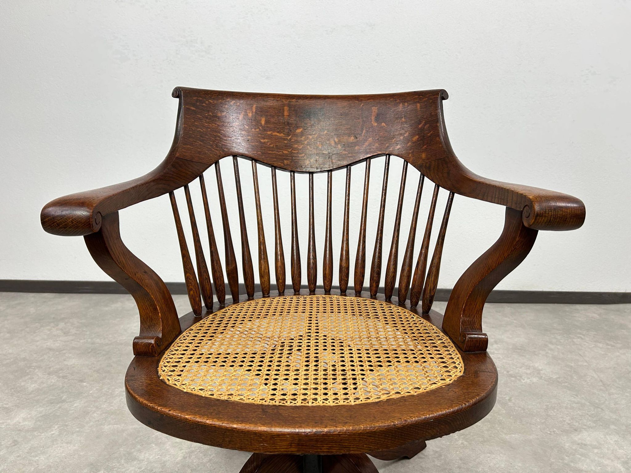 Swivel office chair in oak with a rattan seat.