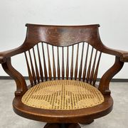 Swivel office chair in oak with a rattan seat.