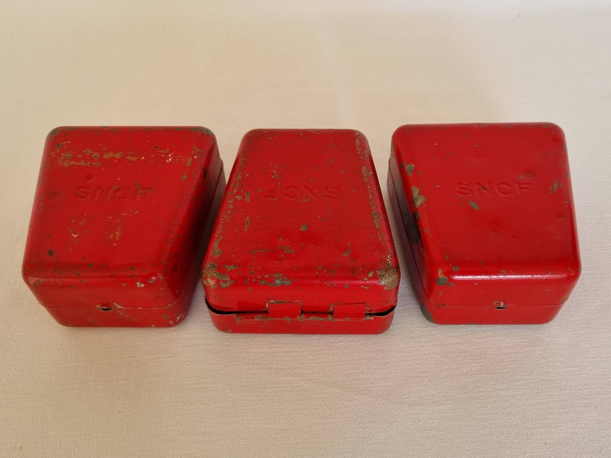 Set of three red painted metal railway boxes with SNCF logo