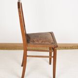 Art Deco style chair in carved wood and leather.