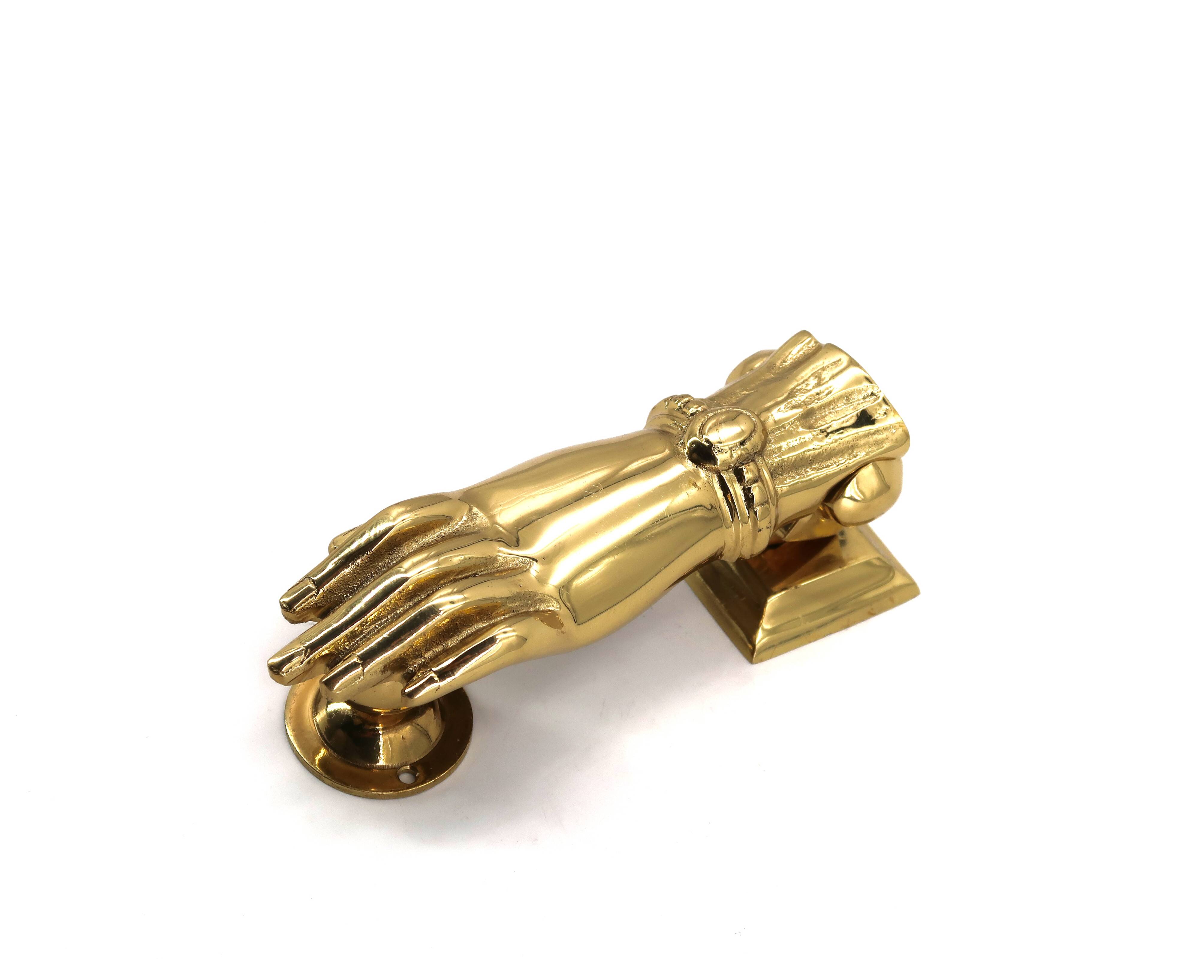 Brass door knocker in the shape of a hand, 1970s.