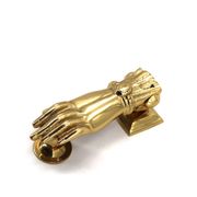 Brass door knocker in the shape of a hand, 1970s.