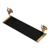 Wall shelf in gold metal and black glass adorned with fish.