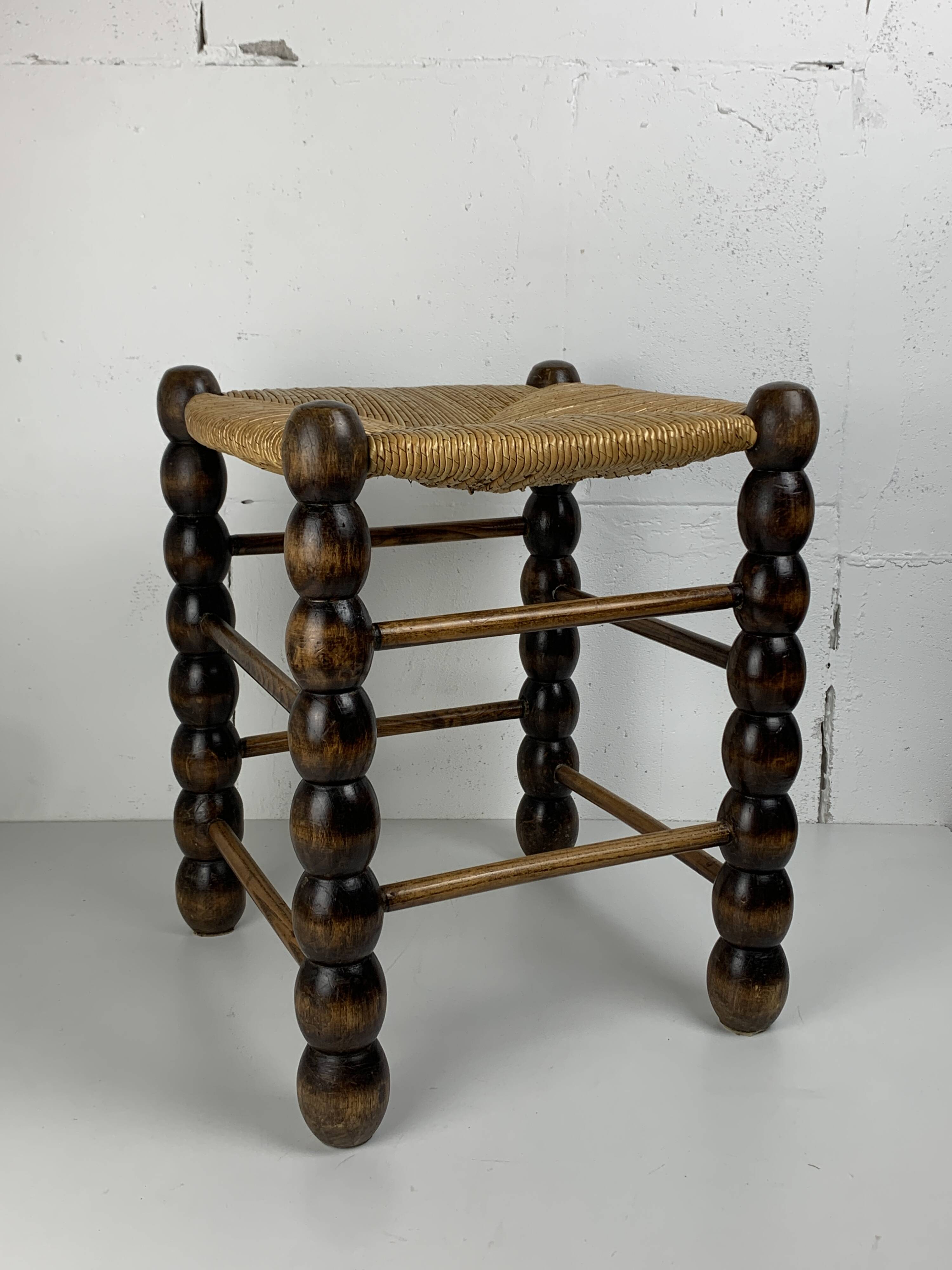 Brutalist wood turned bobbin rush stool in the style of Charles Dudouyt