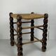 Brutalist wood turned bobbin rush stool in the style of Charles Dudouyt