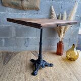 Bistro table with central cast iron leg and rustic top