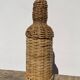 Antique woven wicker bottle