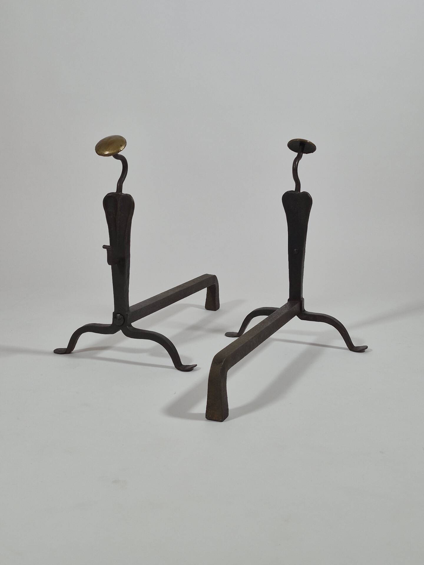 Pair of handforged metal and brass andirons