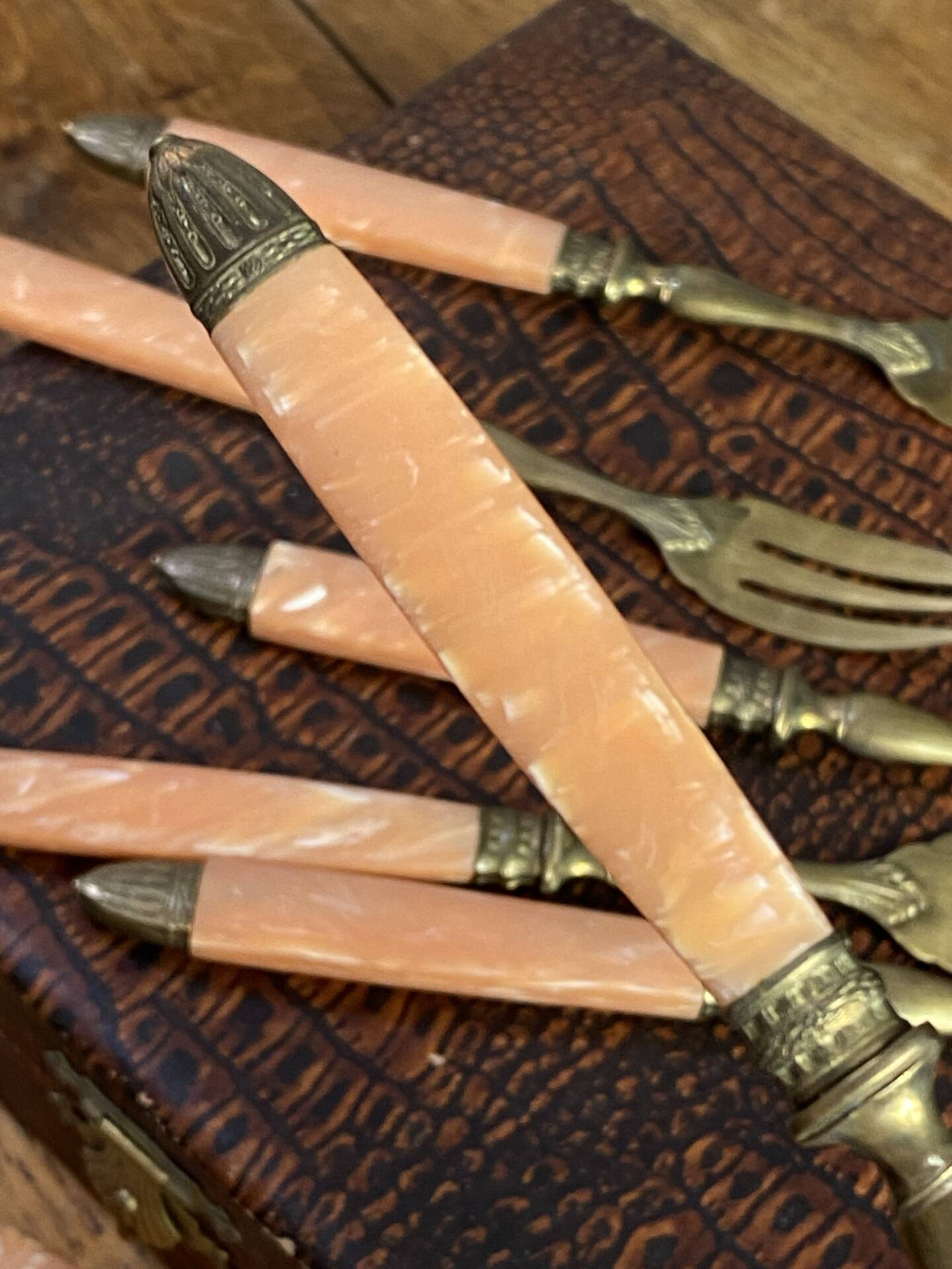 Dessert forks in brass and Bakelite in their case.