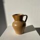 Small pitcher in light beige sandstone