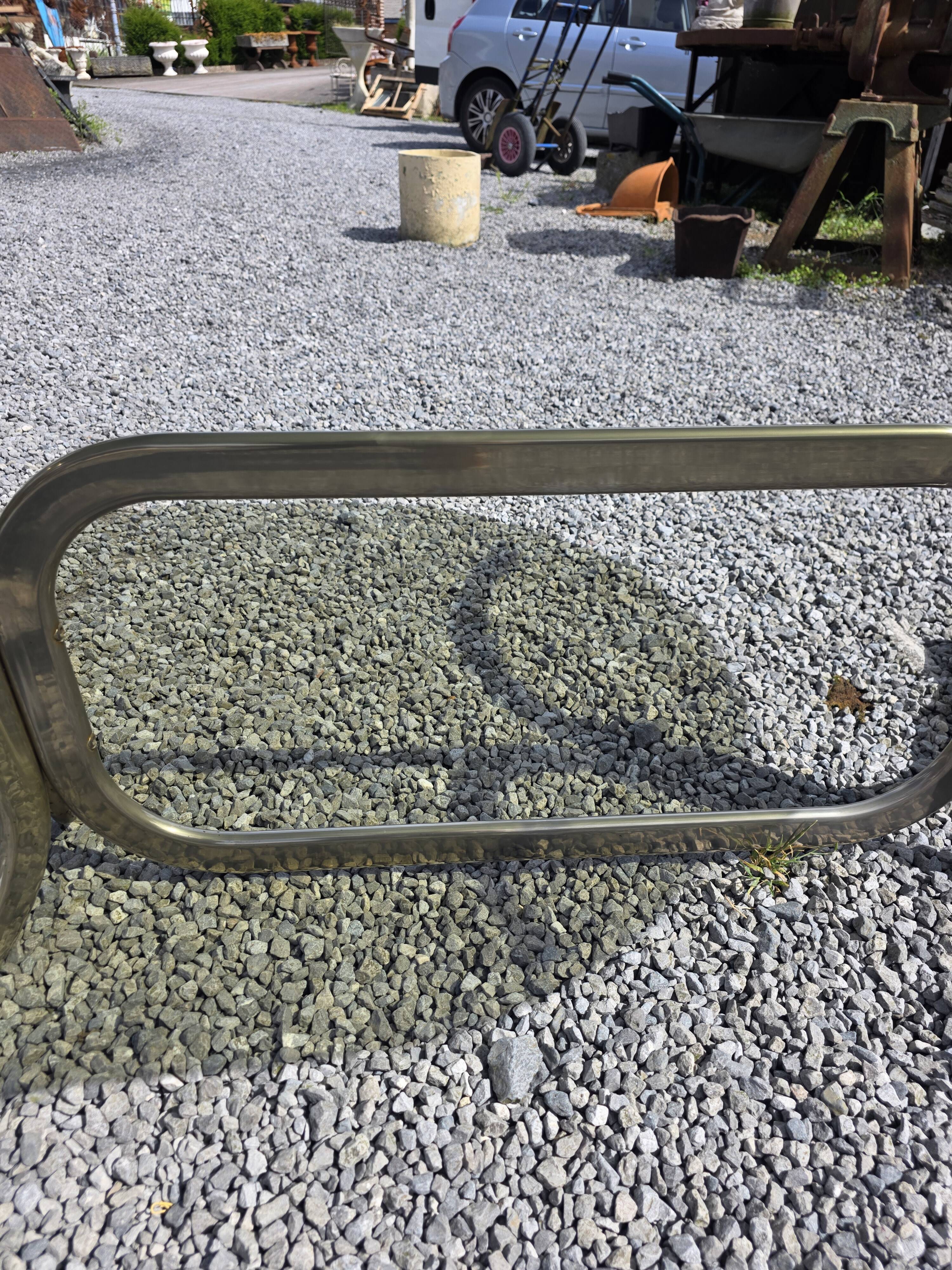 Silver metal table with smoked glass top from the 1970s.