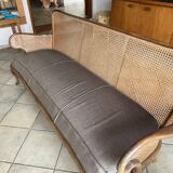 Sofa with backrest and cane armrests