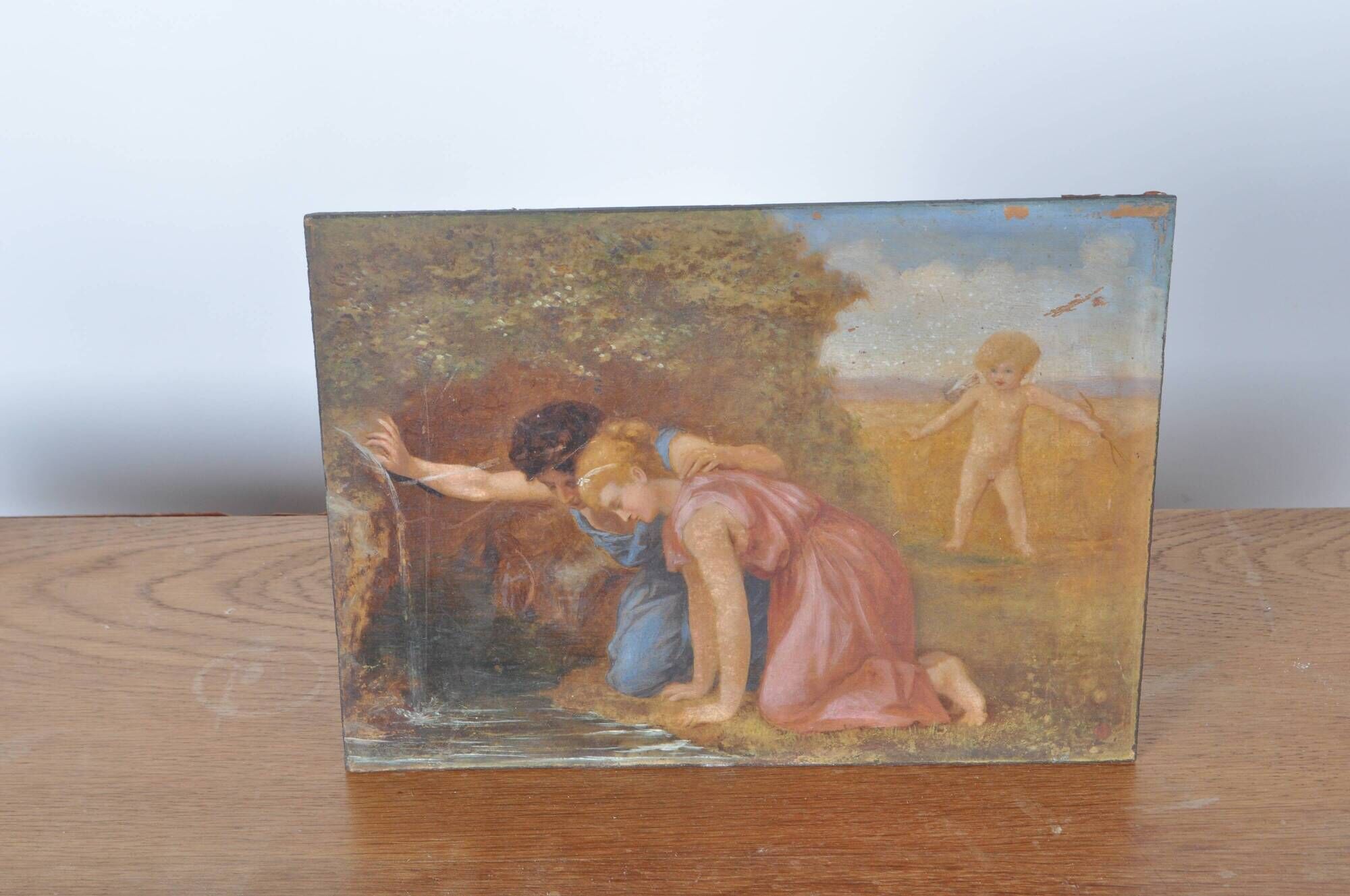 Painting on wood "Cupid and a couple at the fountain".