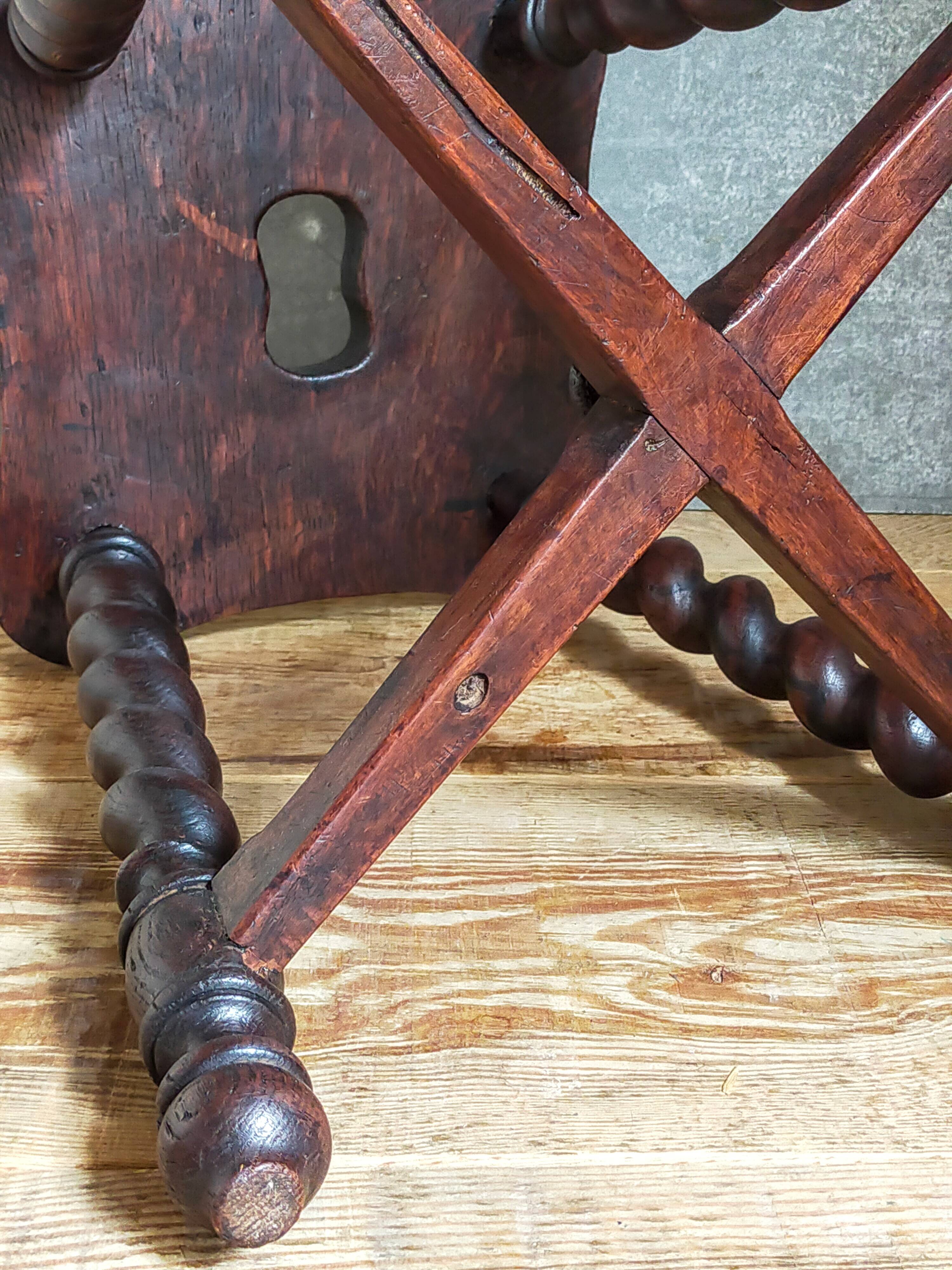 Antique stool in turned and carved solid wood