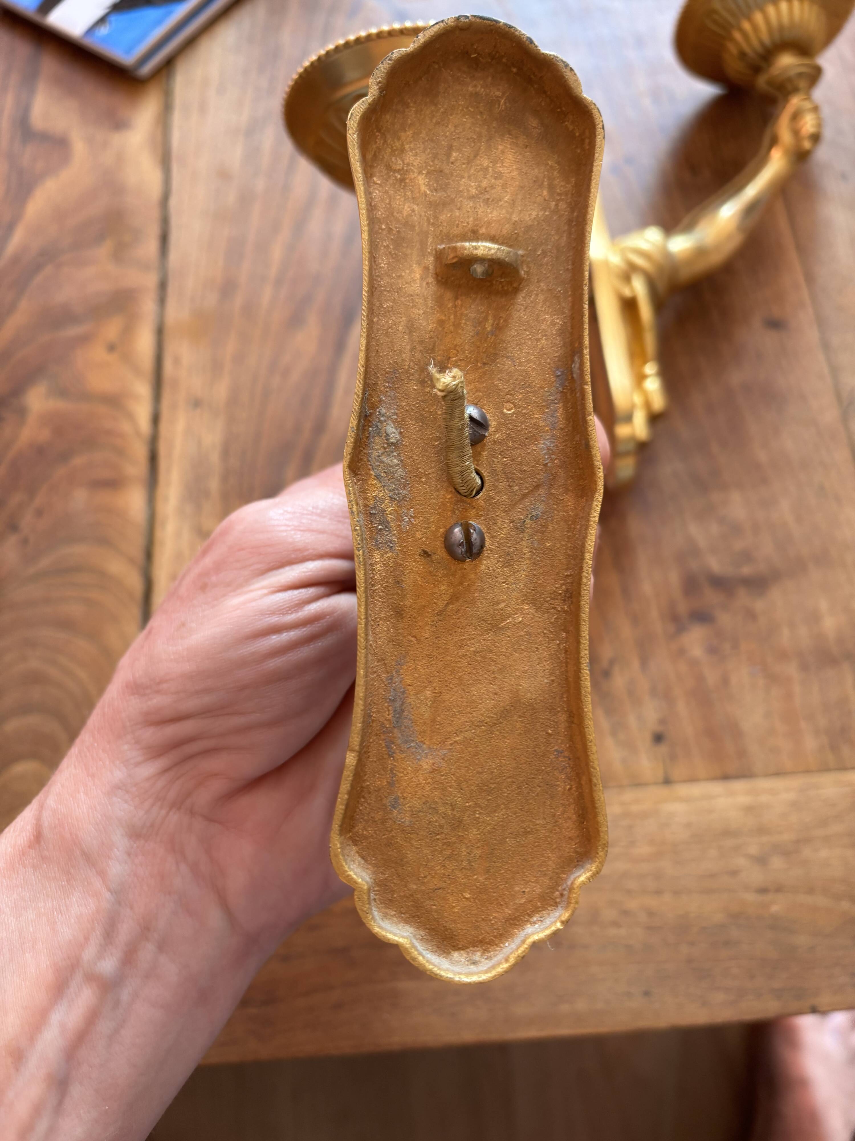Pair of bronze wall sconces with outstretched arms and hands