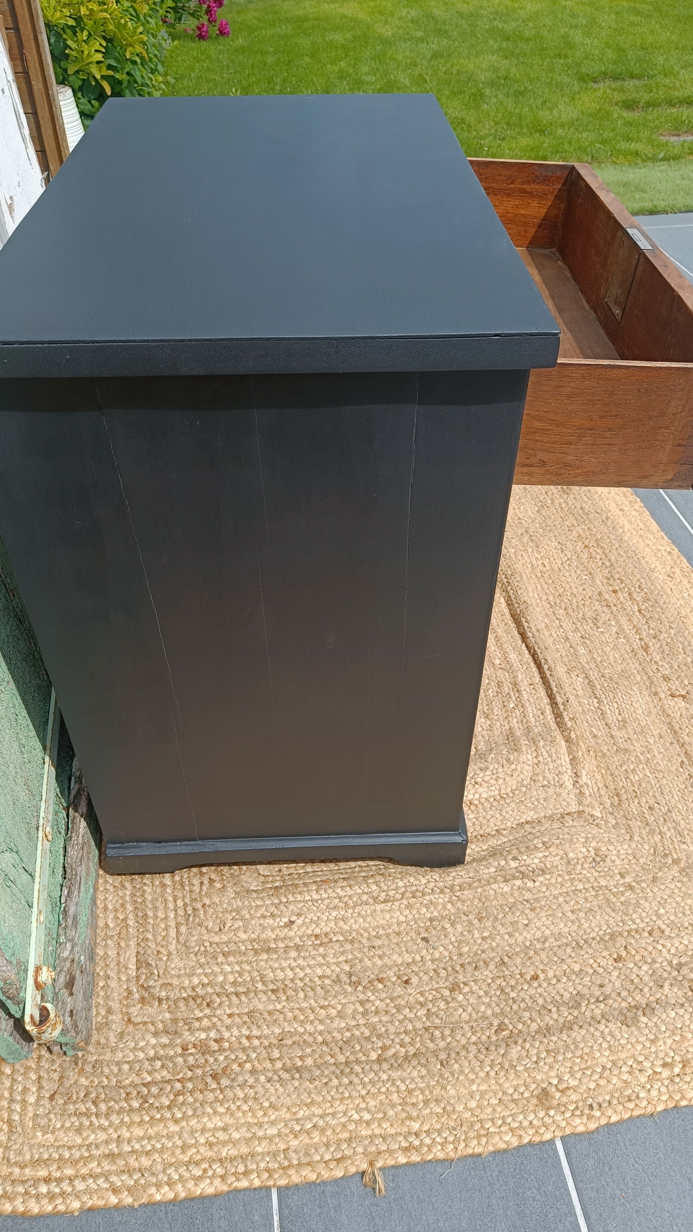 Vintage commode revamped in matte black & wood with warm tones.