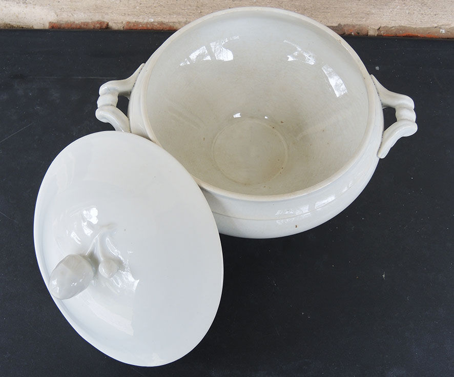 Old white ceramic soup bowl pine cone
