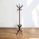 Vintage coat rack on floor in curved wood, thonet style