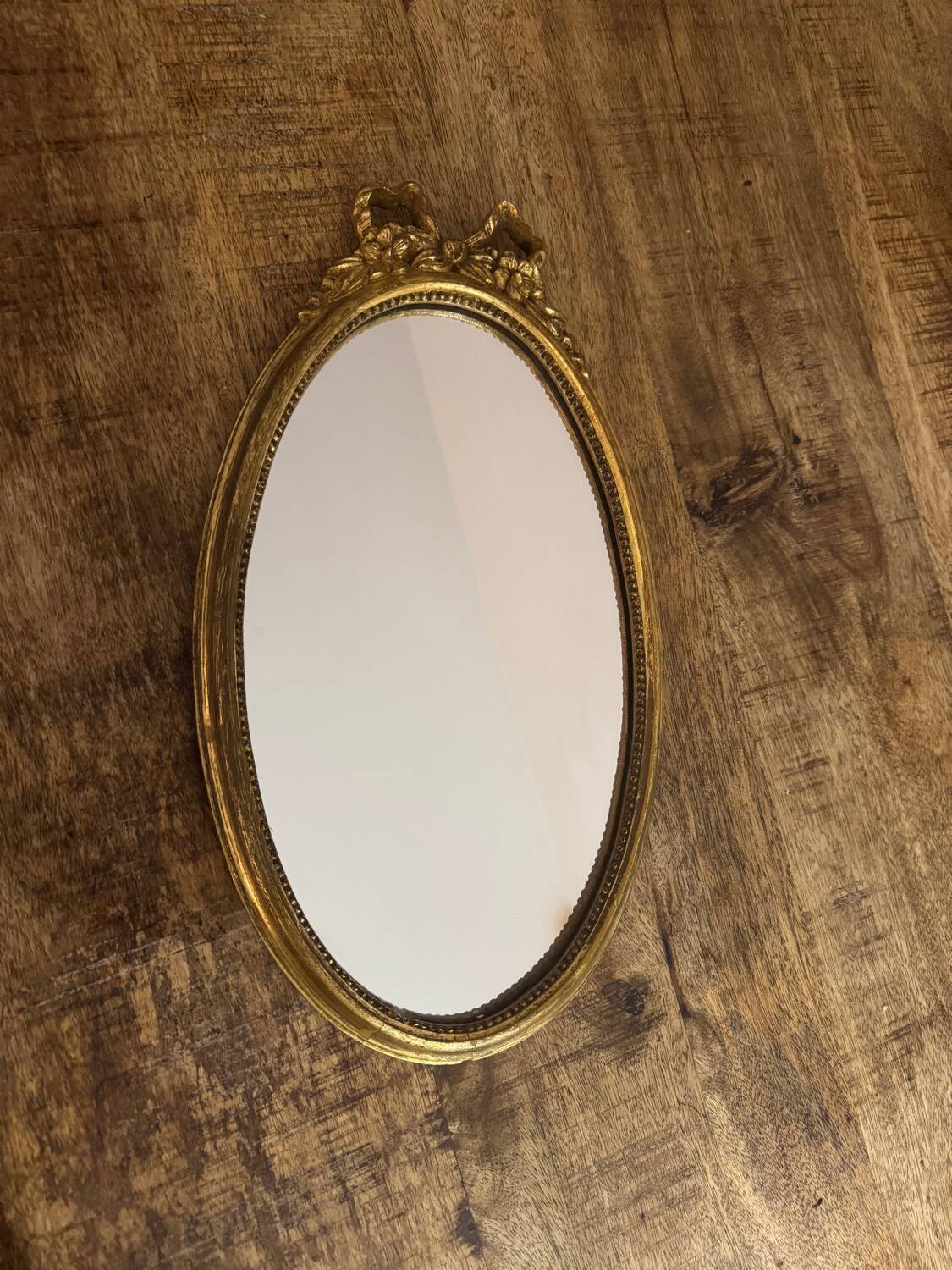 Oval gold knot mirror
