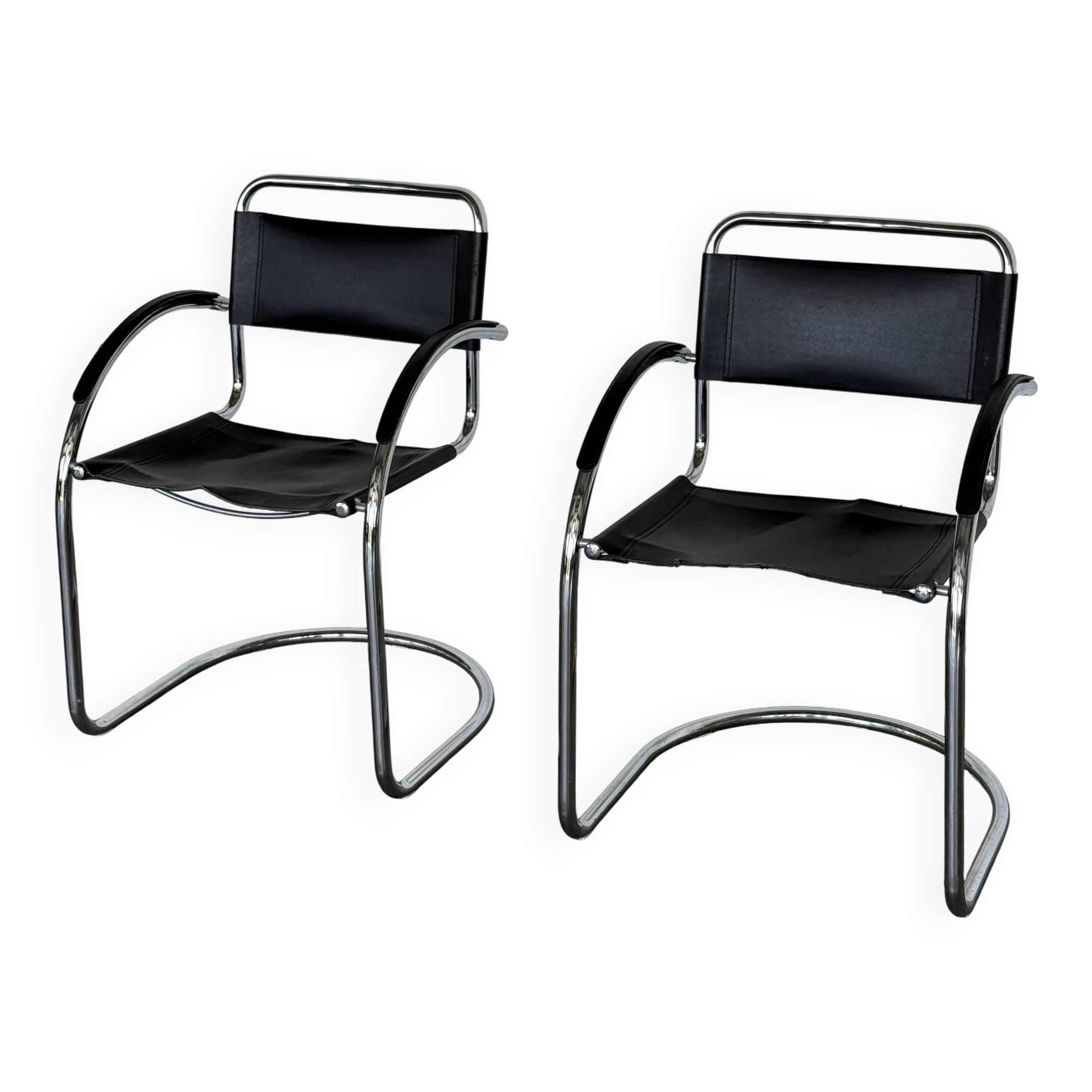 Vintage cantilever chairs in black saddle leather and chrome.