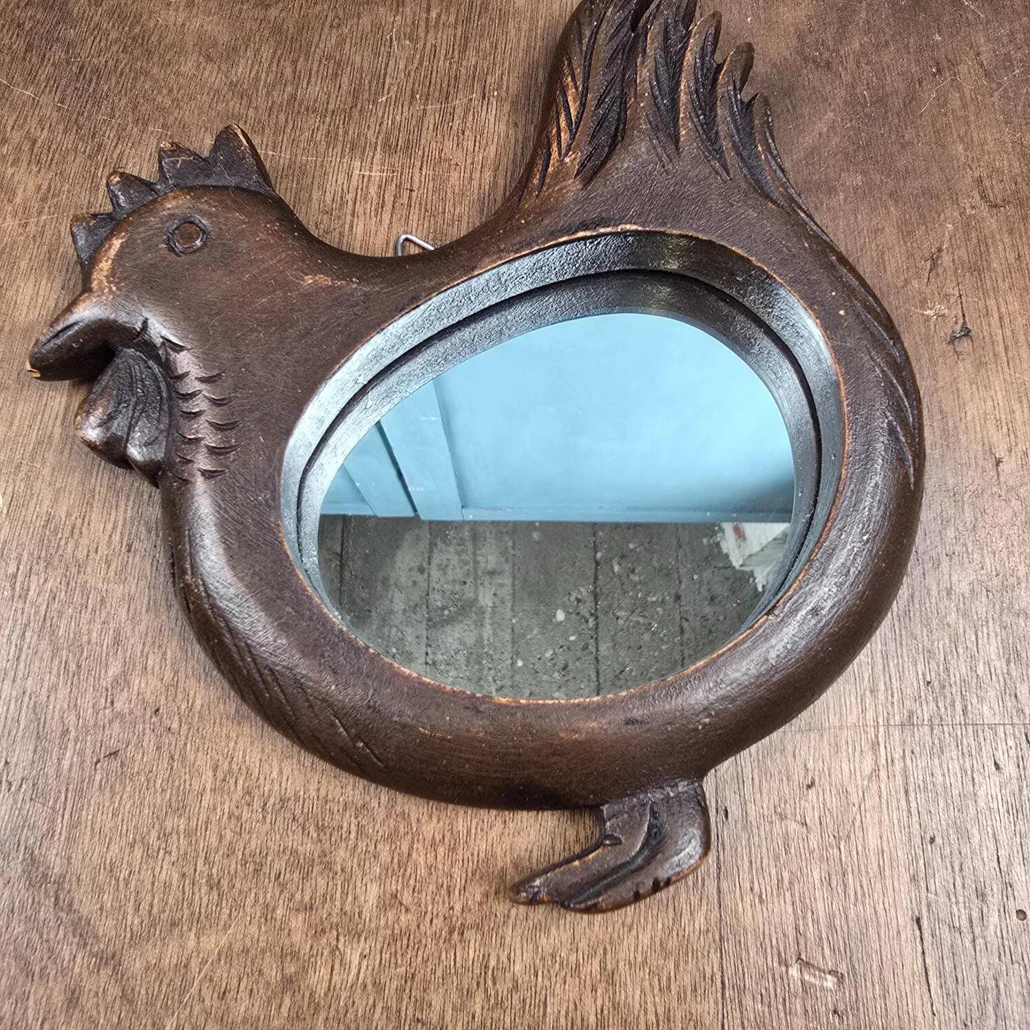 Vintage carved wooden chicken-shaped wall mirror.