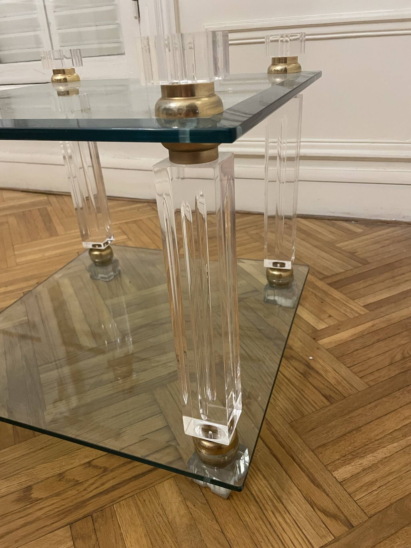 Glass side table with gold decorations.