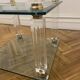 Glass side table with gold decorations.