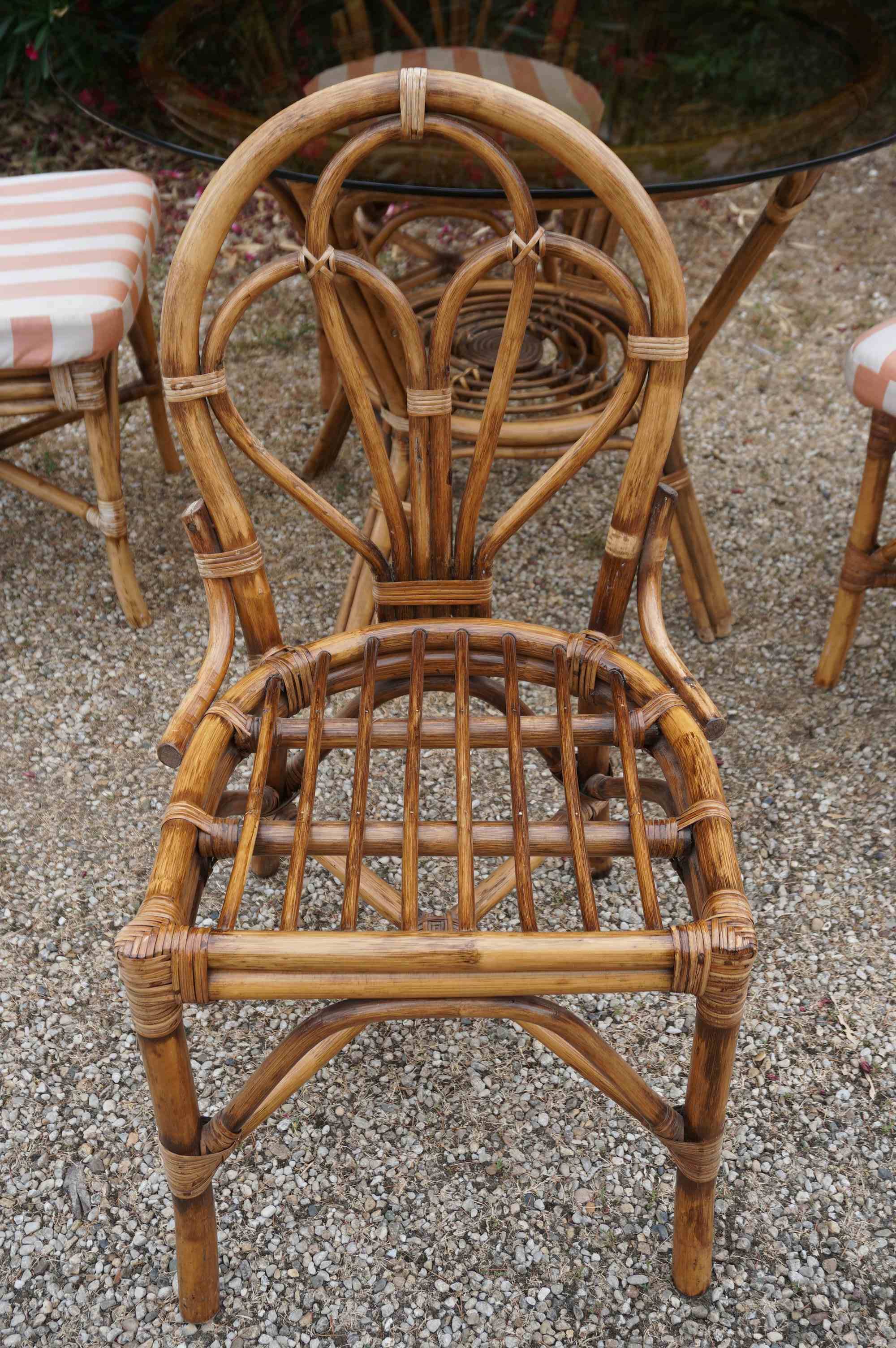 dining table and chairs made of curved bamboo and rattan with smoked glass from the 1970s