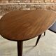 A pair of tripod and nesting coffee tables in walnut and midnight blue.