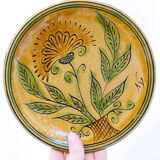 Bulgarian artisanal plate with autumn-hued flower