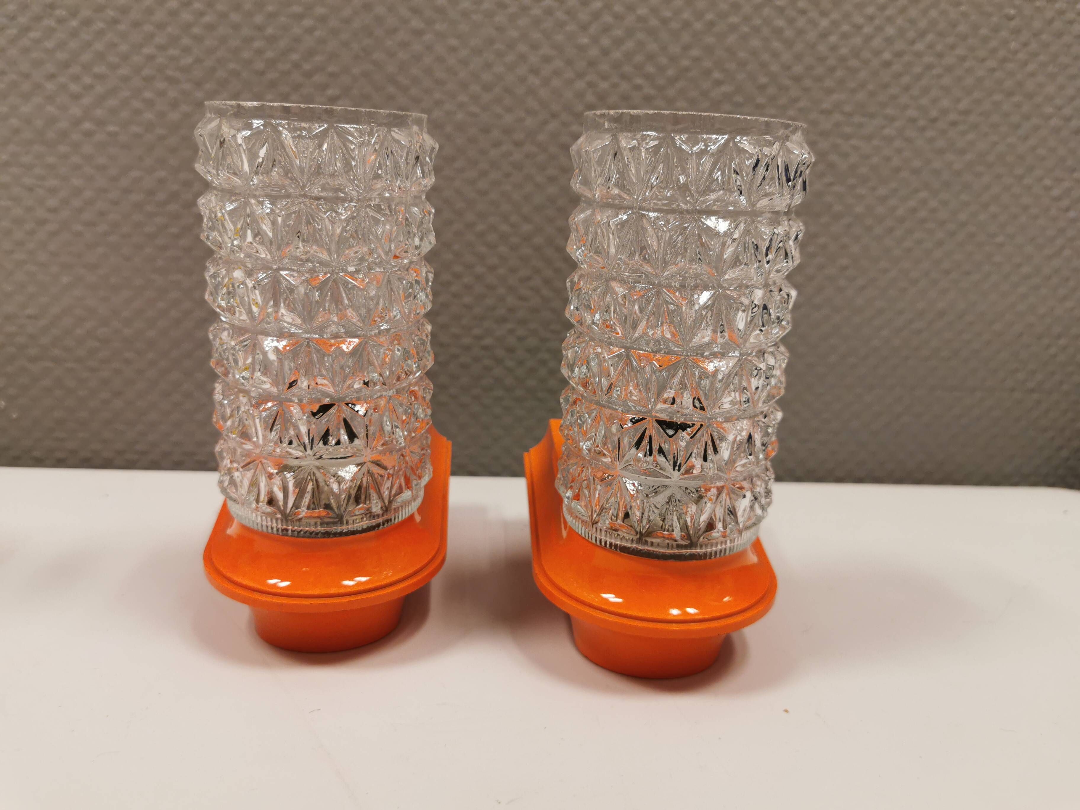 Bathroom lamps in a nice orange colour with a crystal glass shade and a base of hard thin plastic