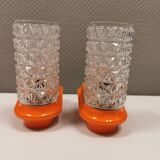 Bathroom lamps in a nice orange colour with a crystal glass shade and a base of hard thin plastic