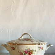 Antique porcelain soup bowl with floral decoration and golden border