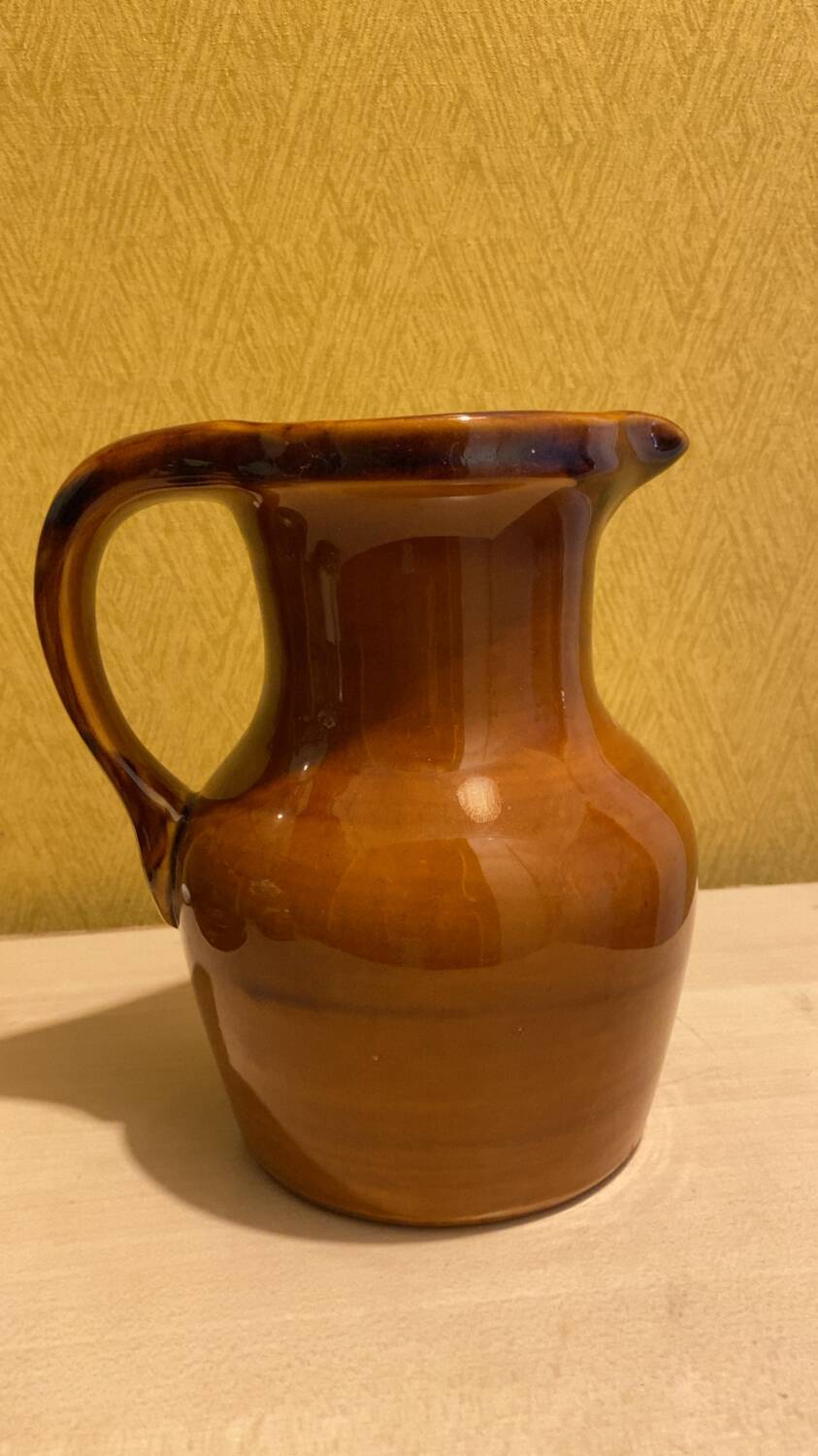 St. Clement brown ceramic pitcher, 1970