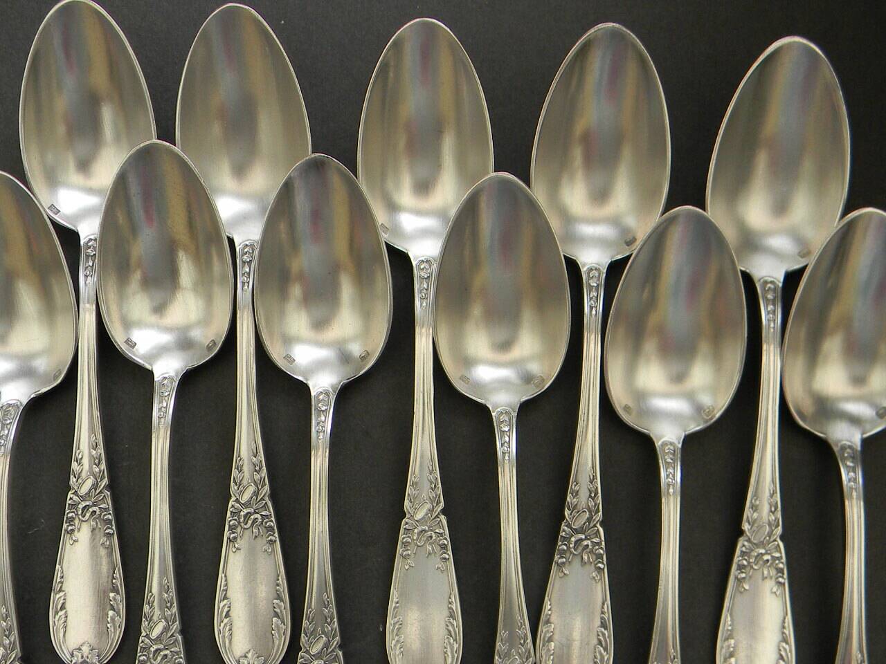 Set of 11 SFAM silver metal teaspoons.