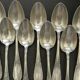 Set of 11 SFAM silver metal teaspoons.