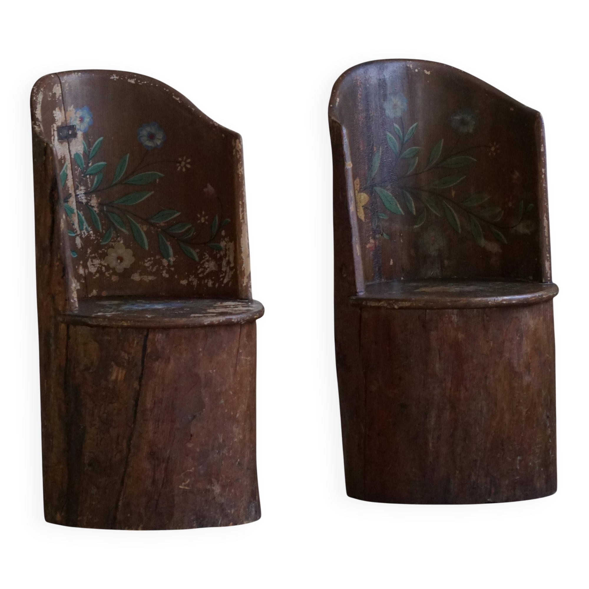 Pair of Swedish folk art stump chairs, decorated with painted floral motifs, late 19th century.