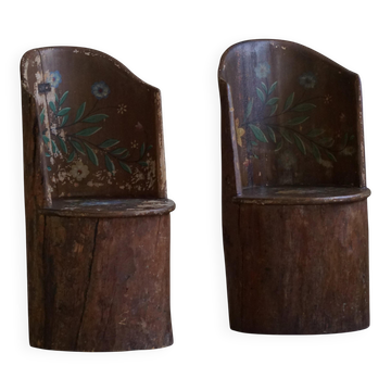 Pair of Swedish folk art stump chairs, decorated with painted floral motifs, late 19th century.