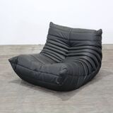 Togo armchair and footrest in black leather by Ligne Roset, designed by Michel Ducaroy.