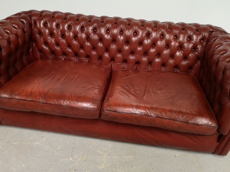 Old red leather Chesterfield sofa