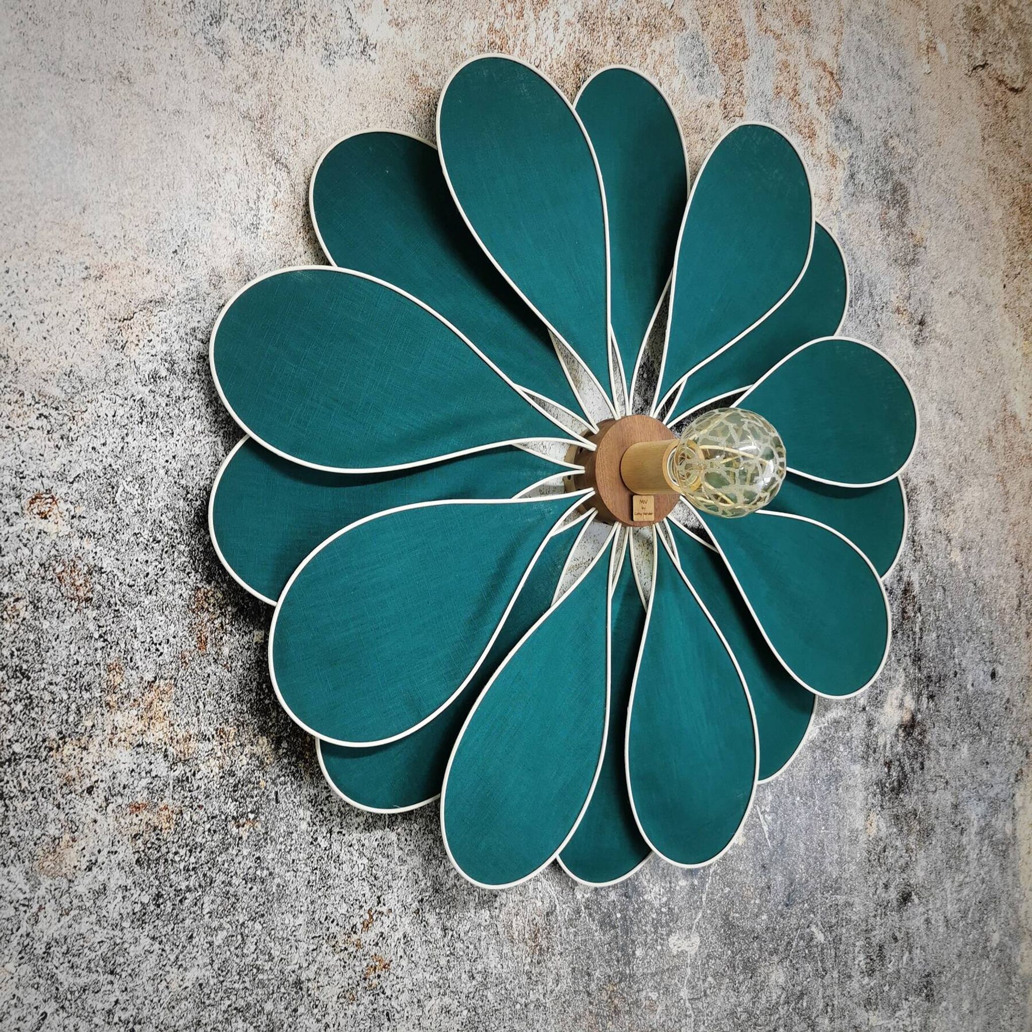 Emerald green rattan and linen flower wall light with 16 petals