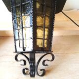 Large hanging lantern in wrought iron and opaque yellow-orange windows