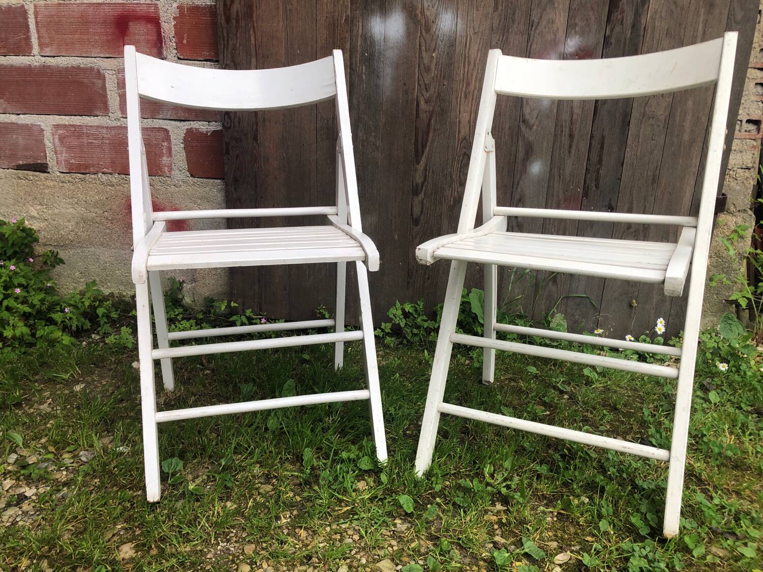 Pair of vintage white wooden folding chairs