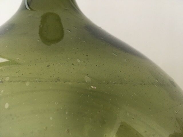 Old demijohn full of bubbles