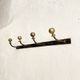 Wall-mounted coat rack with 4 hooks in metal and brass