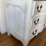 Patinated crossbow chest of drawers.