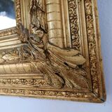 Large gilded wood and stucco mirror with foliage